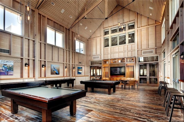 recreation room with wooden walls, wooden ceiling, and high vaulted ceiling