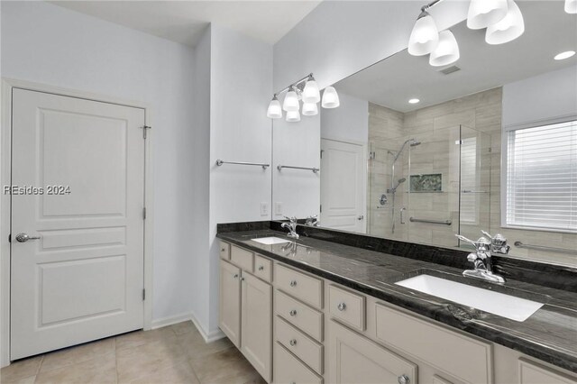 bathroom with vanity, tile patterned flooring, and a shower with door