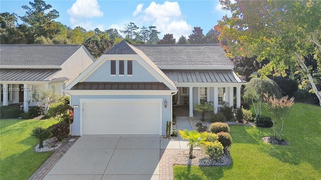 view of front of property featuring a garage and a front yard