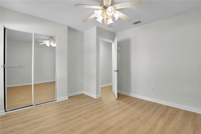 unfurnished bedroom featuring ceiling fan and light wood-type flooring