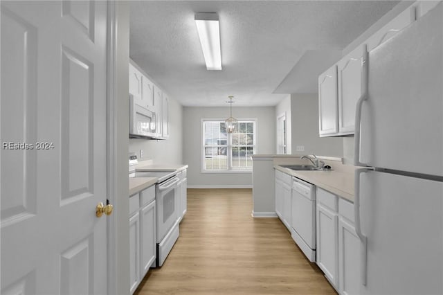 kitchen featuring sink, white appliances, light hardwood / wood-style flooring, white cabinets, and decorative light fixtures