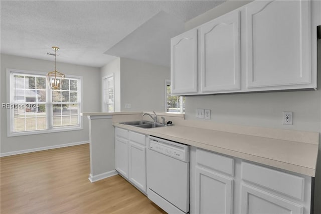 kitchen with white cabinetry, dishwasher, sink, and pendant lighting