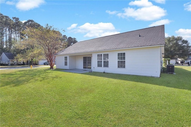 back of property featuring a lawn, a patio, and central air condition unit