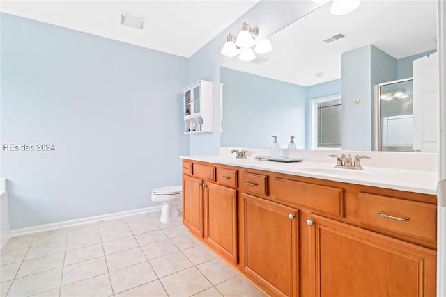 bathroom with vanity, toilet, a shower with shower door, and tile patterned flooring