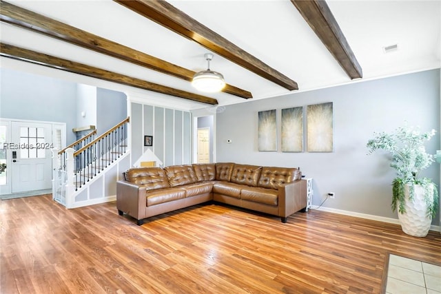 living room featuring beam ceiling, wood-type flooring, and ceiling fan