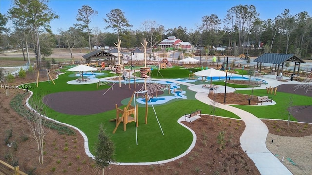 view of community featuring a playground, a gazebo, and a lawn