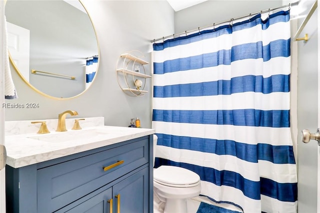 bathroom featuring vanity, toilet, and a shower with shower curtain