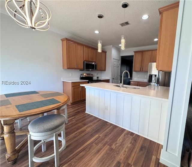 kitchen featuring pendant lighting, sink, crown molding, and stainless steel appliances