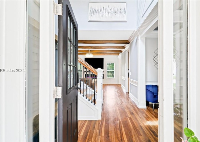 corridor with hardwood / wood-style flooring and beam ceiling