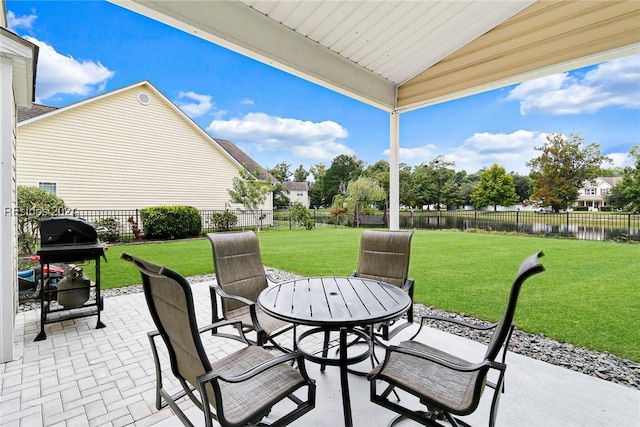 view of patio / terrace with area for grilling and a water view