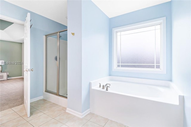 bathroom featuring tile patterned flooring and separate shower and tub