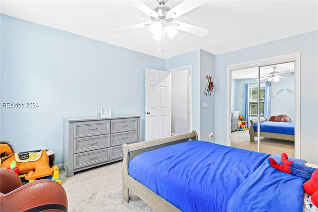 carpeted bedroom with ceiling fan and a closet