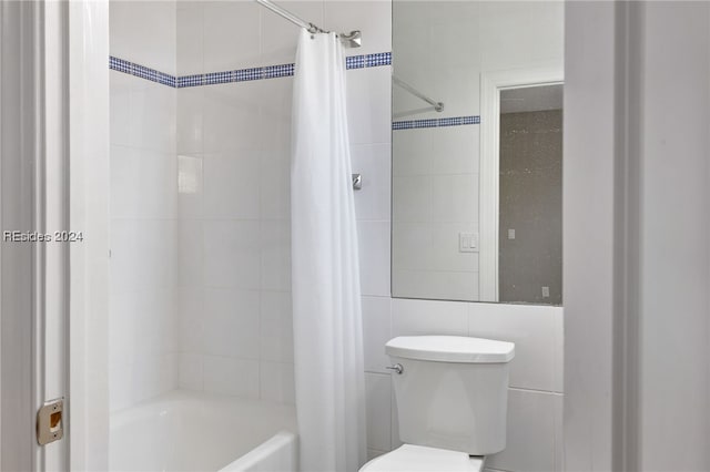 bathroom with shower / bath combo, tile walls, and toilet