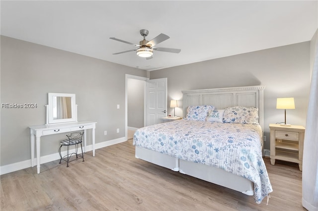 bedroom with ceiling fan and light hardwood / wood-style floors