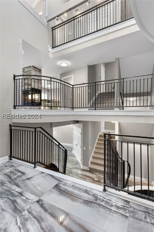 staircase with a towering ceiling