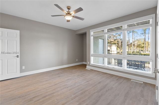 empty room featuring light hardwood / wood-style flooring and ceiling fan