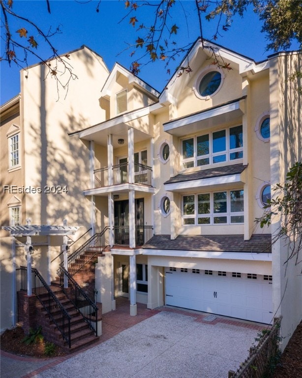 view of front of house featuring a garage and a balcony