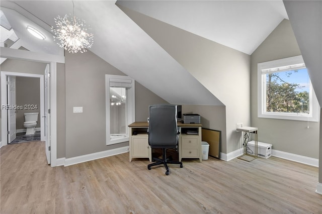 office featuring an inviting chandelier, light hardwood / wood-style flooring, and lofted ceiling