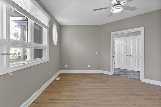 empty room featuring ceiling fan and light wood-type flooring