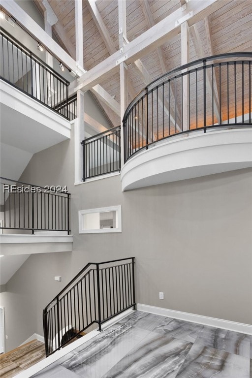 stairs with high vaulted ceiling and wooden ceiling