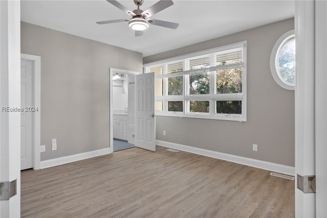 unfurnished bedroom with light hardwood / wood-style flooring, ceiling fan, and ensuite bathroom