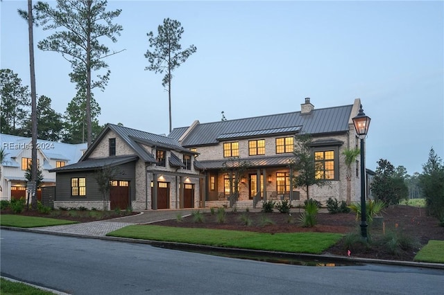 modern farmhouse style home featuring covered porch and a front lawn