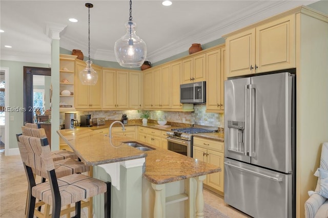 kitchen with stainless steel appliances, sink, a kitchen bar, and decorative light fixtures