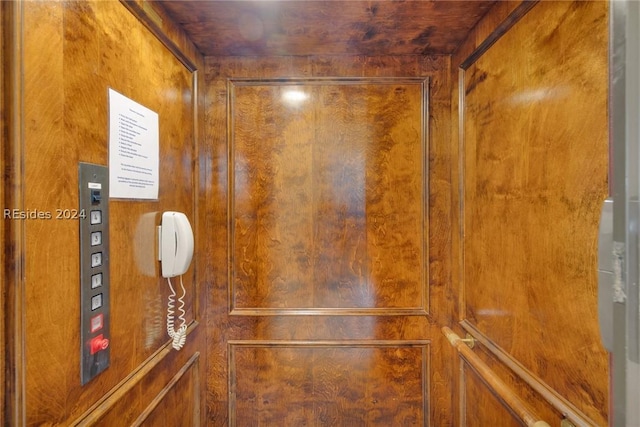 interior details featuring elevator and wood walls