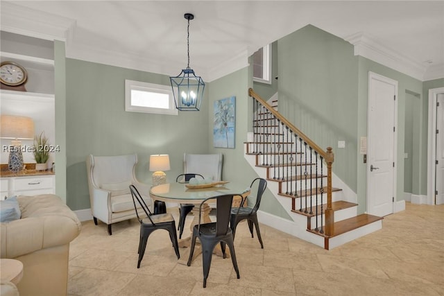 dining area featuring ornamental molding and a notable chandelier