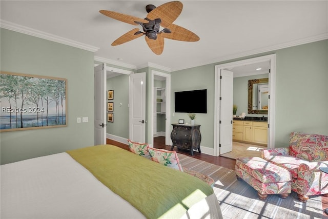 bedroom featuring crown molding, ensuite bath, a closet, hardwood / wood-style flooring, and ceiling fan