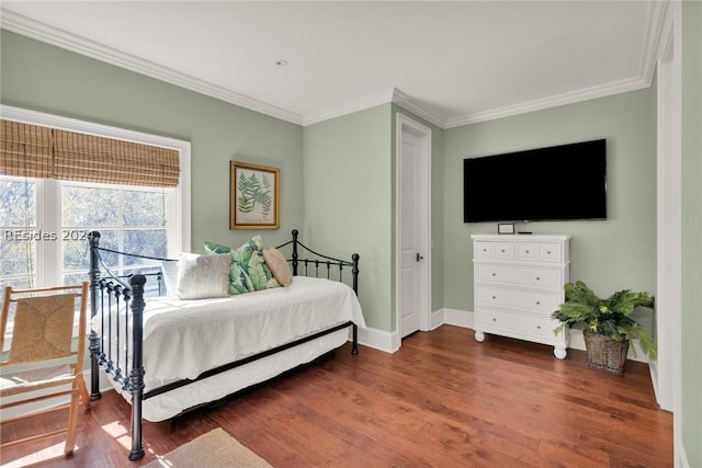 bedroom with crown molding and dark hardwood / wood-style floors