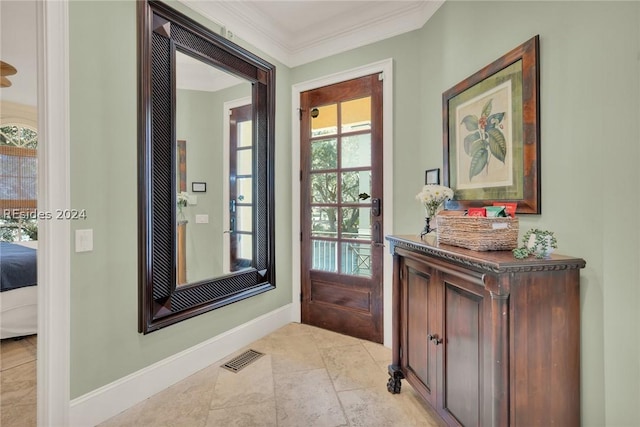 entryway with ornamental molding and plenty of natural light