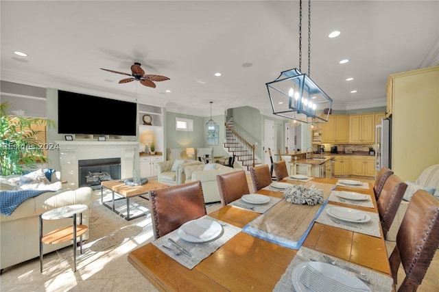 dining space featuring ornamental molding, light tile patterned floors, and ceiling fan