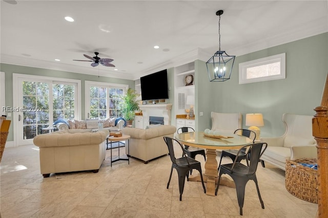 dining room with ornamental molding, ceiling fan, and built in shelves