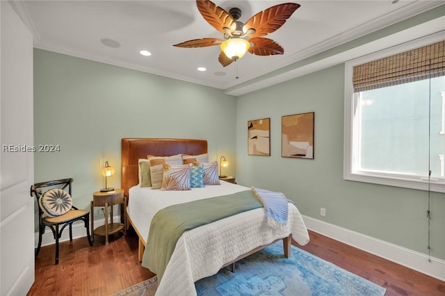 bedroom with crown molding, ceiling fan, and hardwood / wood-style flooring