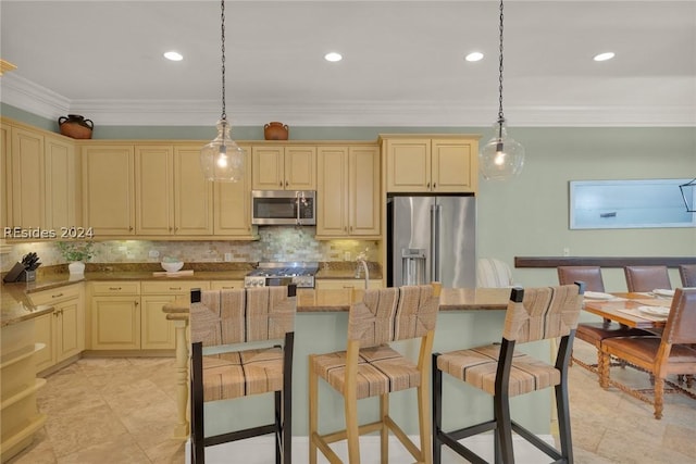 kitchen featuring tasteful backsplash, appliances with stainless steel finishes, a center island, and pendant lighting