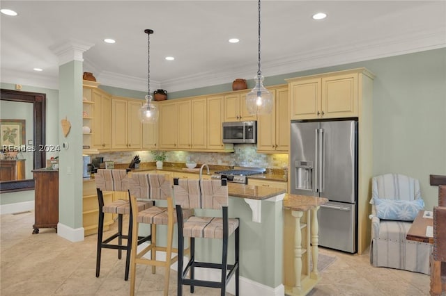 kitchen featuring decorative backsplash, ornamental molding, stainless steel appliances, light stone countertops, and a center island with sink