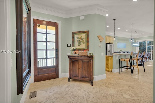 entryway featuring ornamental molding