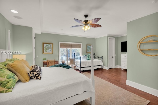 bedroom featuring dark hardwood / wood-style flooring, crown molding, and ceiling fan