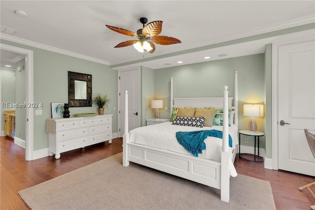 bedroom featuring dark hardwood / wood-style flooring, ornamental molding, and ceiling fan