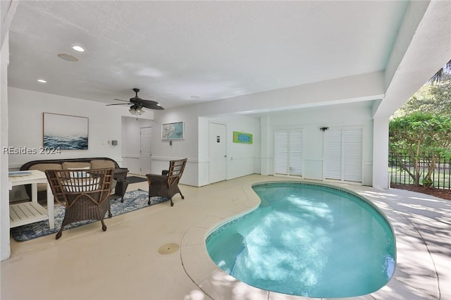 view of swimming pool featuring a hot tub and ceiling fan