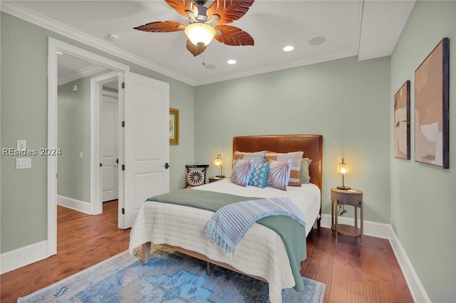 bedroom featuring crown molding, dark wood-type flooring, and ceiling fan