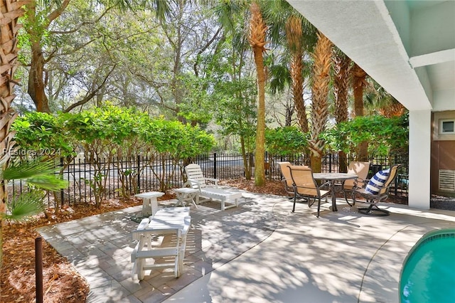 view of patio / terrace with a fenced in pool