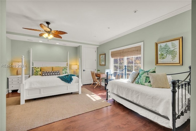 bedroom featuring dark hardwood / wood-style flooring, ornamental molding, and ceiling fan