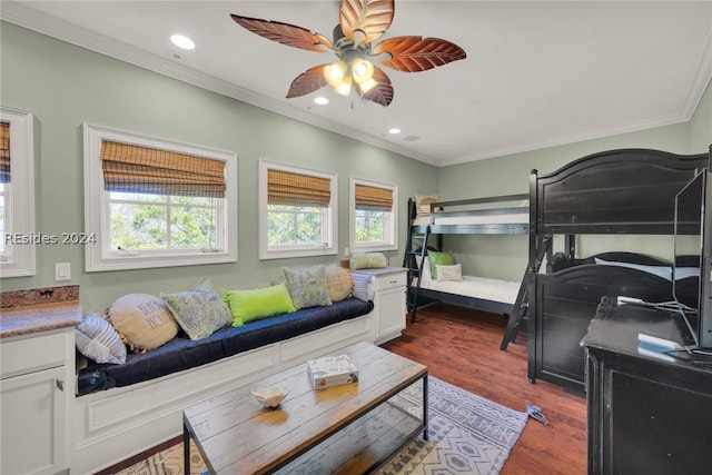 bedroom featuring ceiling fan, ornamental molding, and dark hardwood / wood-style floors