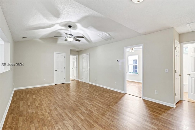 empty room featuring hardwood / wood-style flooring, ceiling fan, and lofted ceiling