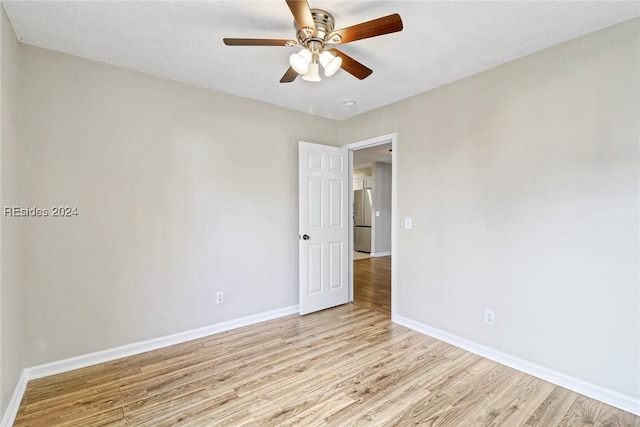 unfurnished room with ceiling fan and light hardwood / wood-style floors