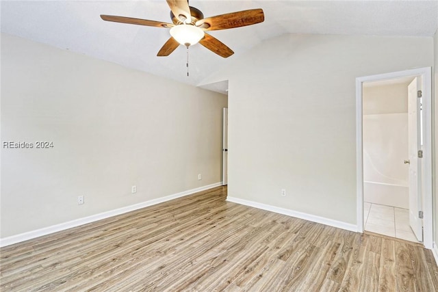 unfurnished room with ceiling fan, lofted ceiling, and light wood-type flooring