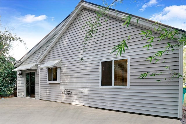 view of property exterior with a patio