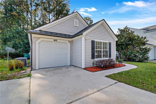 view of front of home with a garage, central AC, and a front lawn